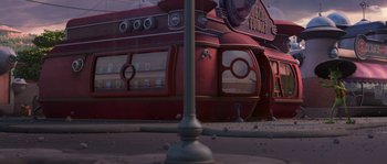 Movie still from “Planet 51” (2009), directed by Javier Abad – View of a building in a city street; Extreme Wide shot, Low angle