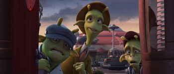 Movie still from “Planet 51” (2009), directed by Javier Abad – A group of people standing next to each other in a parking lot; Medium shot, High angle