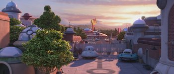 Movie still from “Planet 51” (2009), directed by Javier Abad – An amusement park with a lot of cars parked on the side of the road; Extreme Wide shot, High angle