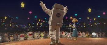 Movie still from “Planet 51” (2009), directed by Javier Abad – An image of a person in a spaceman suit in front of a crowd of people; Wide shot, Low angle