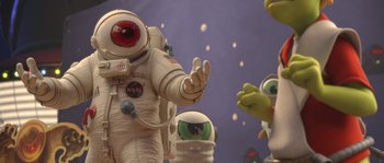 Movie still from “Planet 51” (2009), directed by Javier Abad – An image of an astronaut and aliens in space; Medium shot, Low angle