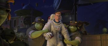 Movie still from “Planet 51” (2009), directed by Javier Abad – A man in a spacesuit is surrounded by three green men; Medium shot, Over the shoulder angle