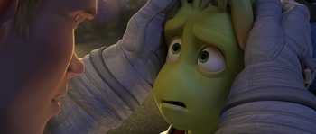 Movie still from “Planet 51” (2009), directed by Javier Abad – A person touching a cartoon character's face; Close Up shot, Over the shoulder angle