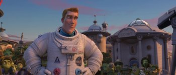 Movie still from “Planet 51” (2009), directed by Javier Abad – An image of a man in a space suit in front of a building; Medium shot, Low angle