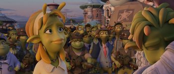 Movie still from “Planet 51” (2009), directed by Javier Abad – A group of people that are standing in a room; Medium shot, Over the shoulder angle