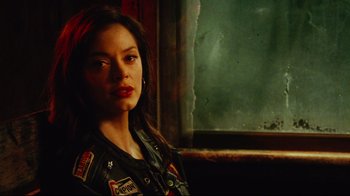 Movie still from “Planet Terror” (2007), directed by Robert Rodriguez – A woman in military fatigues standing in front of a window; Close Up shot, Low angle