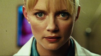 Movie still from “Planet Terror” (2007), directed by Robert Rodriguez – A woman's face in a white lab coat; Close Up shot, Low angle