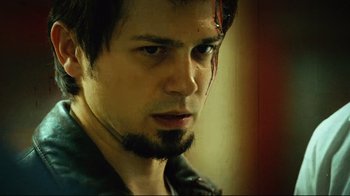 Movie still from “Planet Terror” (2007), directed by Robert Rodriguez – A person wearing a leather jacket; Close Up shot, Low angle