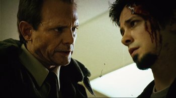 Movie still from “Planet Terror” (2007), directed by Robert Rodriguez – A man and a woman talking to each other; Close Up shot, Low angle