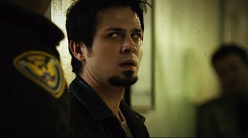 Movie still from “Planet Terror” (2007), directed by Robert Rodriguez – A person with a beard; Close Up shot, Over the shoulder angle