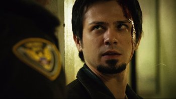 Movie still from “Planet Terror” (2007), directed by Robert Rodriguez – A person wearing a jacket; Close Up shot, Over the shoulder angle