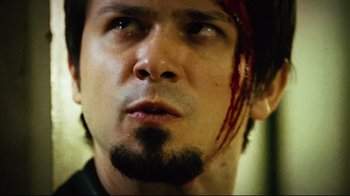 Movie still from “Planet Terror” (2007), directed by Robert Rodriguez – A person with a blood soaked face; Close Up shot, Low angle