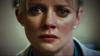 Movie still from “Planet Terror” (2007), directed by Robert Rodriguez – A woman's face with tears in her eyes; Extreme Close Up shot, Low angle