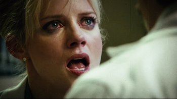 Movie still from “Planet Terror” (2007), directed by Robert Rodriguez – A woman's face as she stares into the distance; Close Up shot, Over the shoulder angle