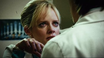 Movie still from “Planet Terror” (2007), directed by Robert Rodriguez – A woman looking at a man in a white shirt; Close Up shot, Over the shoulder angle