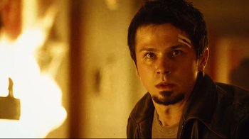 Movie still from “Planet Terror” (2007), directed by Robert Rodriguez – A person wearing a leather jacket; Close Up shot, Low angle