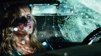 Movie still from “Planet Terror” (2007), directed by Robert Rodriguez – A woman in the back seat of a car with a broken windshield; Close Up shot, Low angle