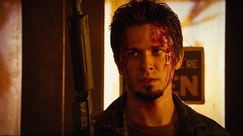 Movie still from “Planet Terror” (2007), directed by Robert Rodriguez – A young man with blood all over his face; Close Up shot, Low angle