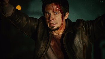 Movie still from “Planet Terror” (2007), directed by Robert Rodriguez – A man in a leather jacket with blood all over his face; Close Up shot, High angle