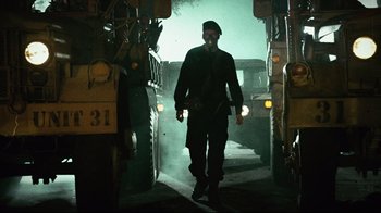 Movie still from “Planet Terror” (2007), directed by Robert Rodriguez – A man with a gas mask walking through a doorway; Wide shot, Low angle