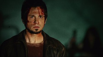 Movie still from “Planet Terror” (2007), directed by Robert Rodriguez – A man with blood all over his face and chest; Close Up shot, Low angle