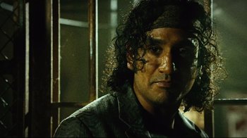 Movie still from “Planet Terror” (2007), directed by Robert Rodriguez – A person wearing a black shirt; Close Up shot, Low angle