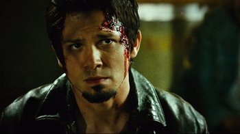 Movie still from “Planet Terror” (2007), directed by Robert Rodriguez – A person with blood on his face; Close Up shot, Over the shoulder angle