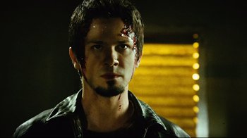 Movie still from “Planet Terror” (2007), directed by Robert Rodriguez – A young man with blood on his face and head; Close Up shot, Low angle