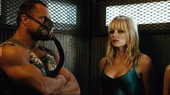 Movie still from “Planet Terror” (2007), directed by Robert Rodriguez – A man and a woman are standing next to each other; Close Up shot, Over the shoulder angle