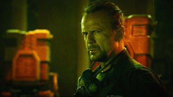 Movie still from “Planet Terror” (2007), directed by Robert Rodriguez – A person wearing headphones; Close Up shot, Low angle