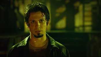 Movie still from “Planet Terror” (2007), directed by Robert Rodriguez – A young man with a face tattoo and a beard; Close Up shot, Low angle