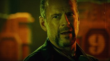 Movie still from “Planet Terror” (2007), directed by Robert Rodriguez – A person wearing a jacket; Close Up shot, Low angle