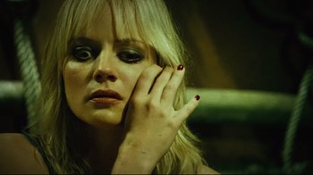 Movie still from “Planet Terror” (2007), directed by Robert Rodriguez – A woman with red nail polish holding her hand up to her face; Close Up shot, High angle