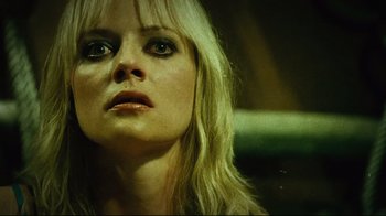 Movie still from “Planet Terror” (2007), directed by Robert Rodriguez – A person with long blonde hair; Close Up shot, Low angle