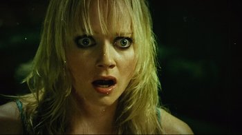 Movie still from “Planet Terror” (2007), directed by Robert Rodriguez – A person's face with long blonde hair; Close Up shot, Low angle