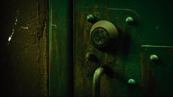 Movie still from “Planet Terror” (2007), directed by Robert Rodriguez – A green door with a metal handle on it's side; Extreme Close Up shot, High angle