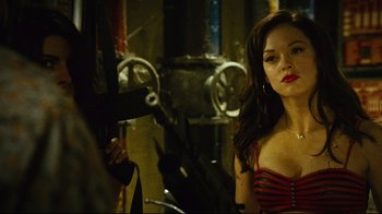 Movie still from “Planet Terror” (2007), directed by Robert Rodriguez – A beautiful woman in a striped top standing in front of a mirror; Close Up shot, Over the shoulder angle