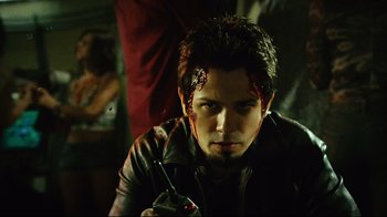 Movie still from “Planet Terror” (2007), directed by Robert Rodriguez – A young man in a leather jacket with blood on his face; Close Up shot, Low angle