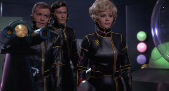 Movie still from “Planet of the Vampires” (1965), directed by Mario Bava – A group of people in black and yellow outfits; Medium shot, Low angle