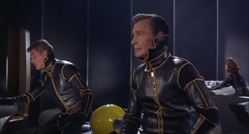 Movie still from “Planet of the Vampires” (1965), directed by Mario Bava – A man in black and yellow leather jacket; Medium shot, Low angle