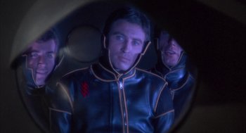 Movie still from “Planet of the Vampires” (1965), directed by Mario Bava – A man in a leather jacket is looking into a mirror; Close Up shot, Over the shoulder angle