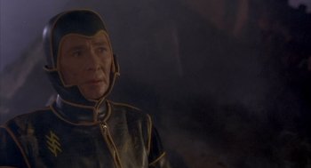 Movie still from “Planet of the Vampires” (1965), directed by Mario Bava – An older man wearing a black and yellow outfit; Close Up shot, High angle