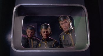 Movie still from “Planet of the Vampires” (1965), directed by Mario Bava – A group of men in space suits looking in a mirror; Medium shot, Low angle