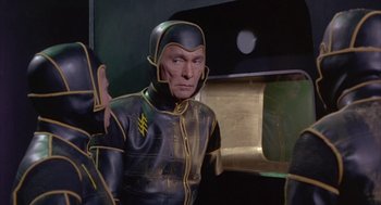 Movie still from “Planet of the Vampires” (1965), directed by Mario Bava – A man in a black and yellow costume; Medium shot, Low angle