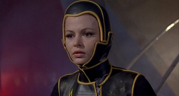 Movie still from “Planet of the Vampires” (1965), directed by Mario Bava – A woman wearing a black and yellow costume; Close Up shot, Low angle