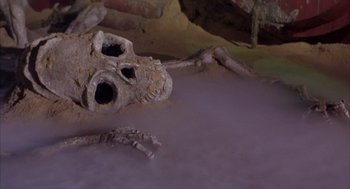 Movie still from “Planet of the Vampires” (1965), directed by Mario Bava – A skull that is laying on the ground; Medium shot, High angle