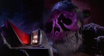 Movie still from “Planet of the Vampires” (1965), directed by Mario Bava – A purple skull sitting in front of a car; Close Up shot, Low angle
