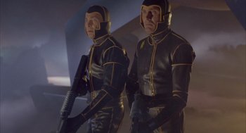 Movie still from “Planet of the Vampires” (1965), directed by Mario Bava – A couple of men in black and yellow suits; Medium shot, Low angle