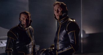 Movie still from “Planet of the Vampires” (1965), directed by Mario Bava – Two men in black and yellow leather suits; Medium shot, Low angle