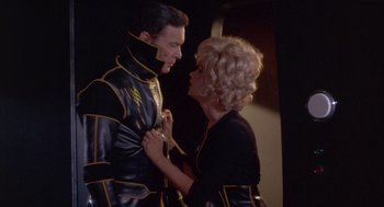 Movie still from “Planet of the Vampires” (1965), directed by Mario Bava – A man and a woman dressed in black and yellow; Medium shot, Low angle